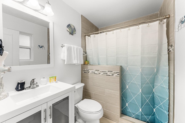 bathroom with vanity, toilet, and a shower with shower curtain