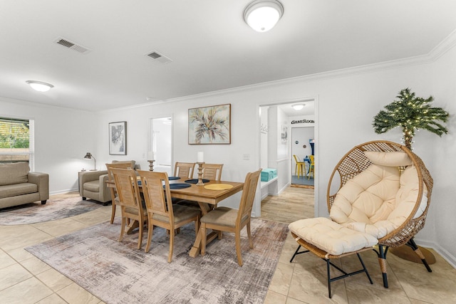 dining space with ornamental molding and light tile patterned floors