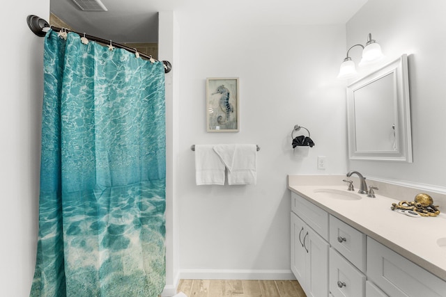 bathroom with vanity and hardwood / wood-style flooring