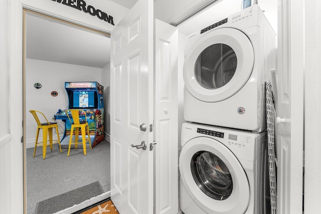 clothes washing area featuring stacked washer and dryer