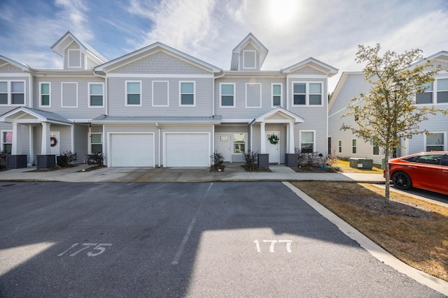 view of property with central AC and a garage