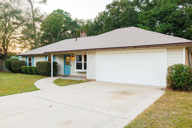 ranch-style house with a garage and a front yard