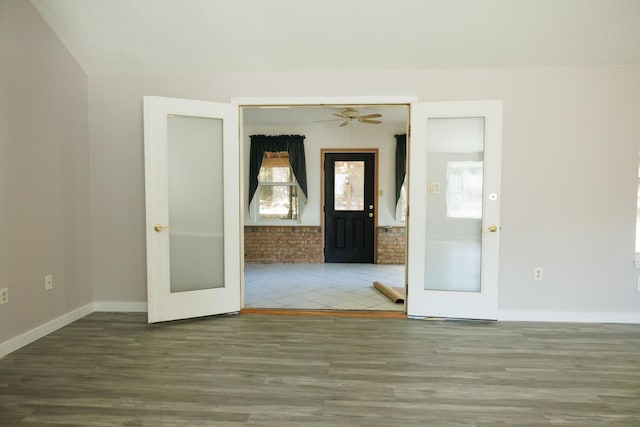 spare room with french doors, a textured ceiling, and hardwood / wood-style flooring