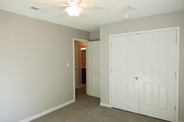 unfurnished bedroom featuring light carpet, ceiling fan, and a closet