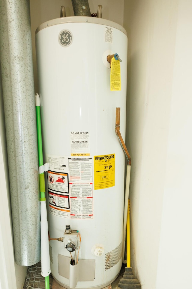 utility room featuring gas water heater