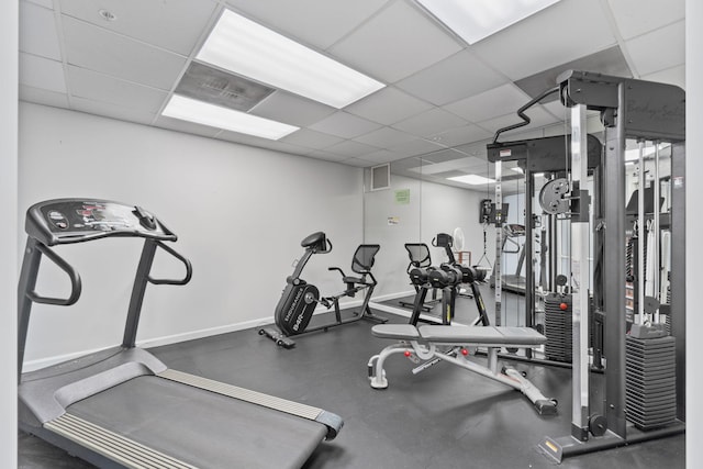 workout area with a paneled ceiling