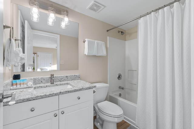 full bathroom with vanity, shower / tub combo, and toilet