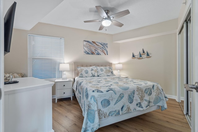 bedroom featuring a closet, ceiling fan, and light hardwood / wood-style flooring