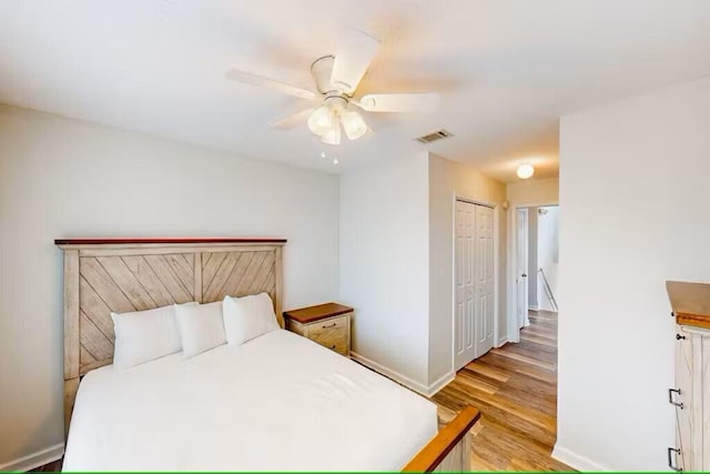 bedroom with ceiling fan, a closet, and light wood-type flooring