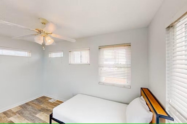 bedroom with ceiling fan and light wood-type flooring