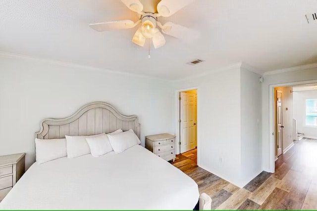 bedroom featuring crown molding, ceiling fan, and light hardwood / wood-style flooring