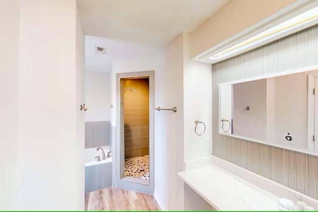 bathroom featuring separate shower and tub and hardwood / wood-style floors