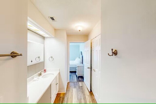 bathroom featuring vanity and wood-type flooring