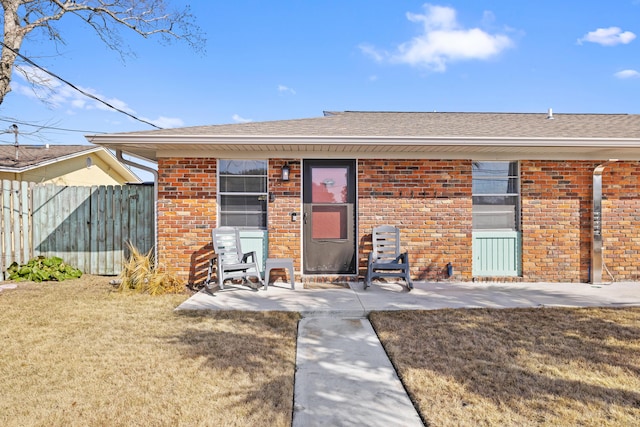 view of front of property featuring a front lawn and a patio area