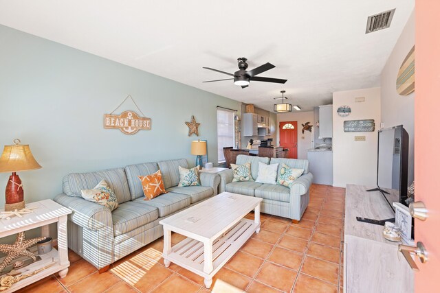 living room with light tile patterned floors and ceiling fan