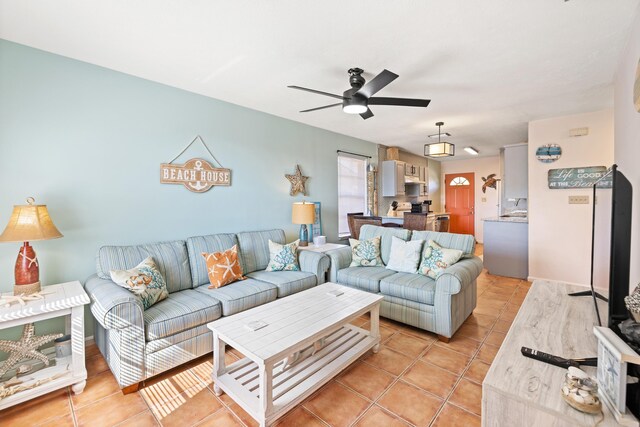 tiled living room with ceiling fan