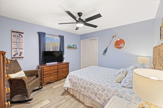 bedroom featuring ceiling fan, light hardwood / wood-style floors, and a closet