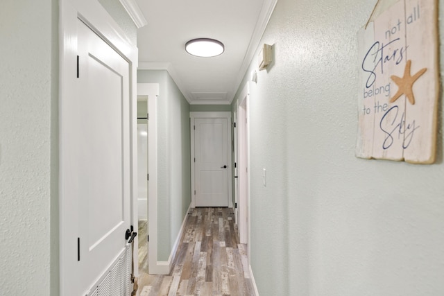 hall featuring crown molding and light wood-type flooring