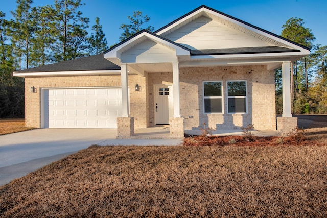 view of front of home with a garage and a porch