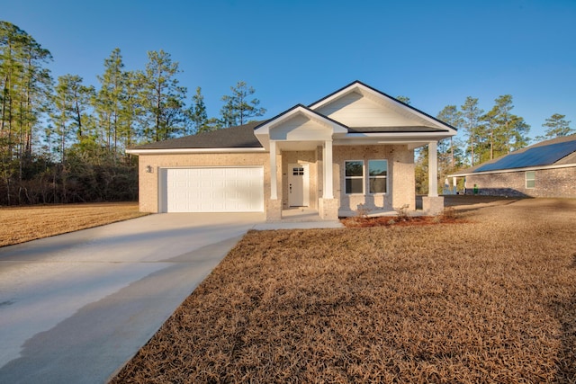 view of front of property featuring a garage and a porch