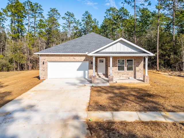 view of front of house featuring brick siding, a porch, a shingled roof, concrete driveway, and an attached garage