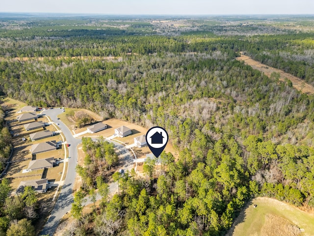 birds eye view of property featuring a view of trees