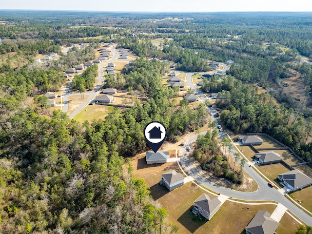 birds eye view of property with a wooded view