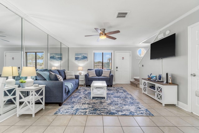 living room featuring light tile patterned flooring, crown molding, and ceiling fan