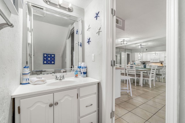 bathroom featuring vanity, tile patterned flooring, and a textured ceiling