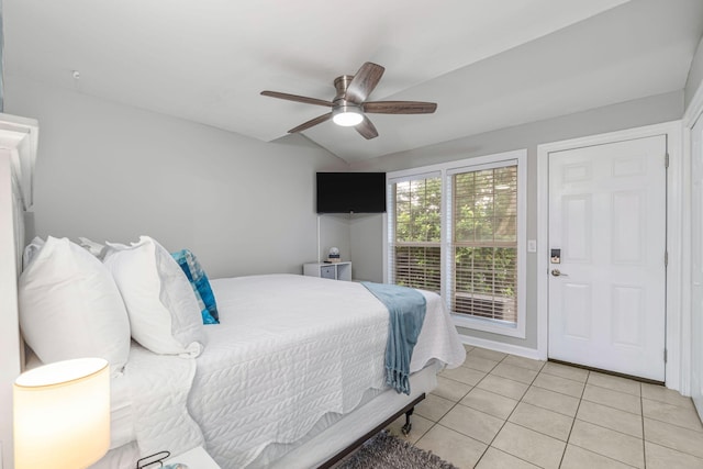 bedroom with lofted ceiling, light tile patterned floors, and ceiling fan