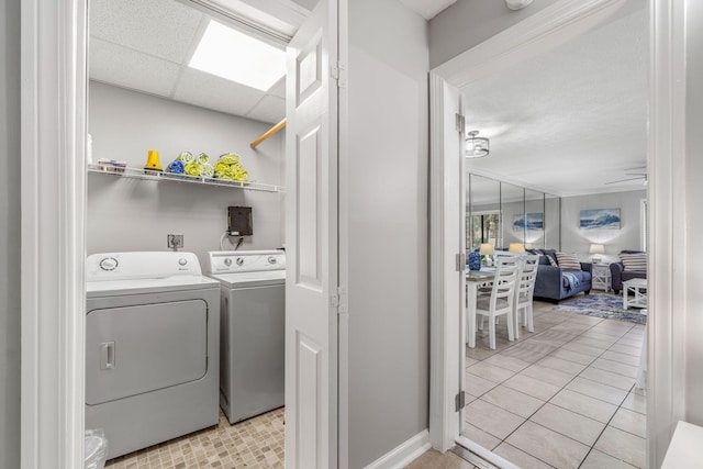 washroom featuring ceiling fan, light tile patterned floors, and independent washer and dryer