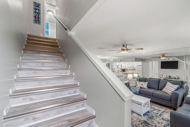 staircase with ceiling fan