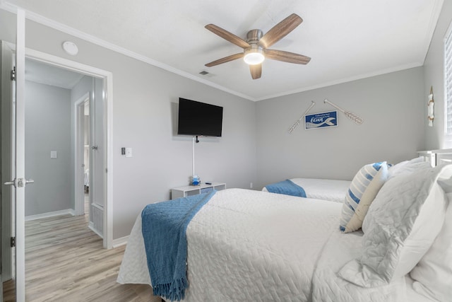 bedroom featuring ornamental molding, ceiling fan, and light hardwood / wood-style flooring