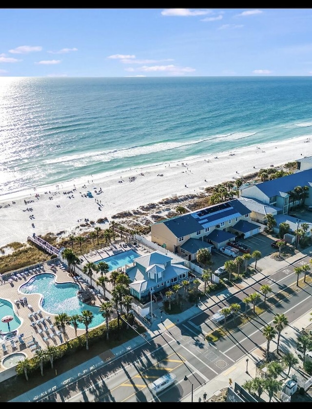 aerial view with a water view and a beach view