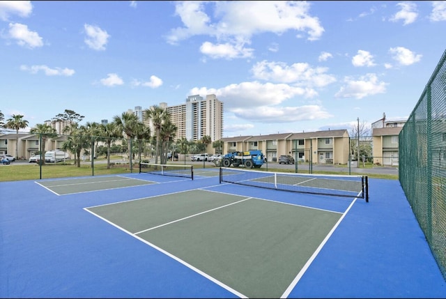 view of tennis court with basketball hoop