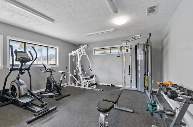 exercise room featuring a textured ceiling