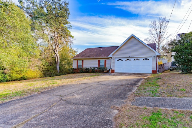 ranch-style house featuring a garage and driveway