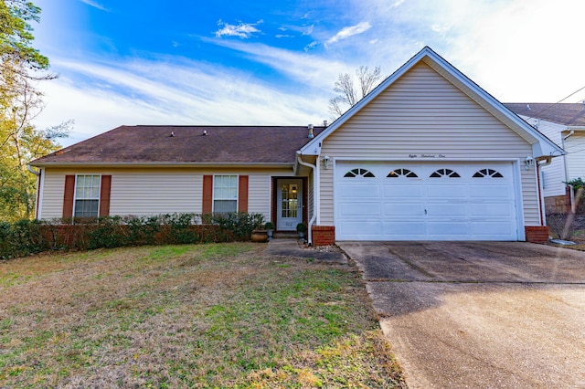 ranch-style home featuring a garage, driveway, and a front lawn