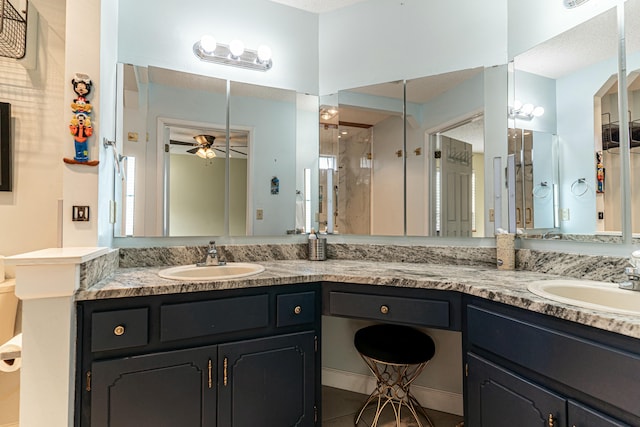 bathroom featuring double vanity, a ceiling fan, and a sink