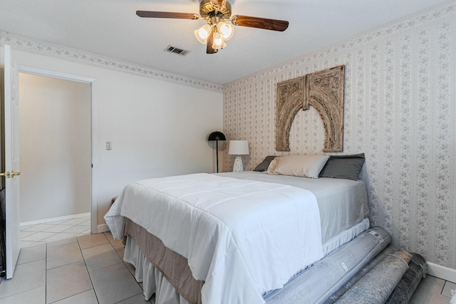 bedroom with light tile patterned floors, a ceiling fan, baseboards, visible vents, and wallpapered walls