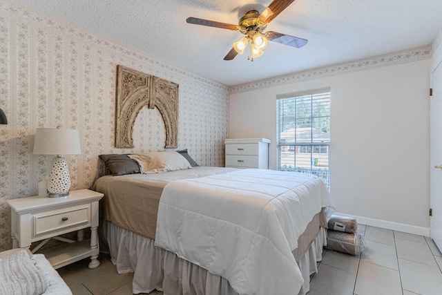 bedroom with a textured ceiling, baseboards, light tile patterned flooring, and wallpapered walls