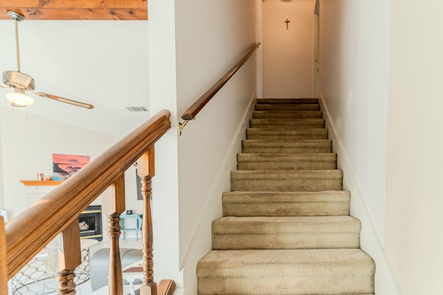 stairway with visible vents and a ceiling fan