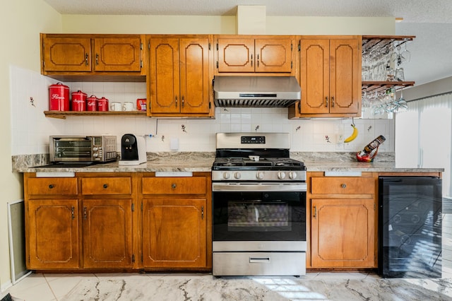 kitchen with a toaster, open shelves, stainless steel gas stove, beverage cooler, and extractor fan