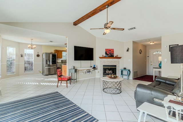 living area with visible vents, lofted ceiling with beams, light tile patterned flooring, a fireplace, and ceiling fan with notable chandelier