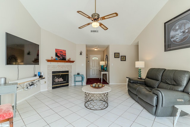 living area with ceiling fan, light tile patterned floors, a fireplace, visible vents, and baseboards