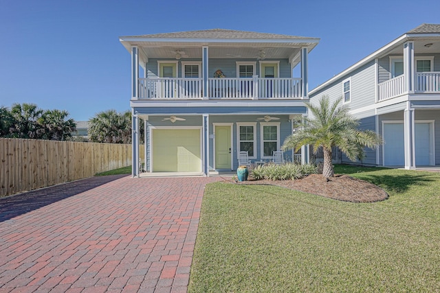 view of front of house with a garage, a front lawn, and a balcony