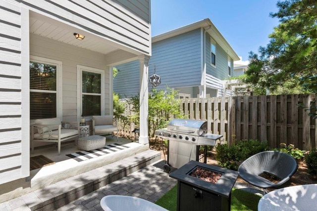 view of patio featuring area for grilling and an outdoor living space with a fire pit