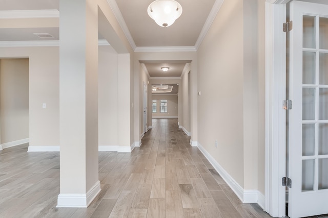 hall with crown molding and light hardwood / wood-style floors