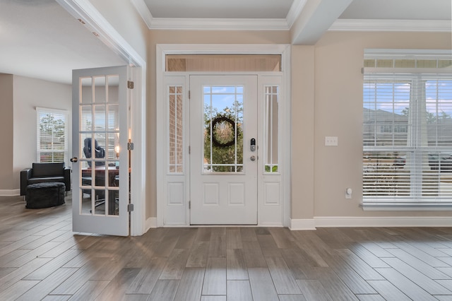 foyer entrance with hardwood / wood-style flooring and crown molding