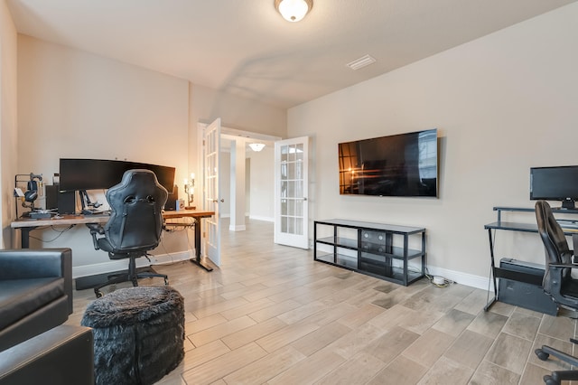 office area featuring light hardwood / wood-style floors and french doors